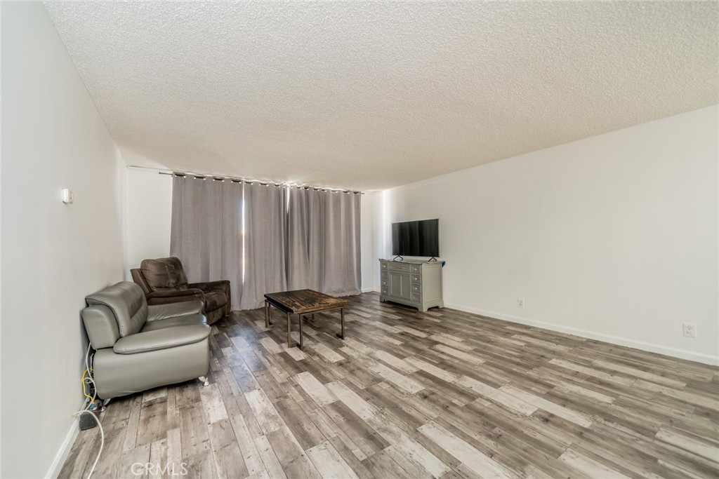 6979 Palm Court, Unit 319F Riverside, CA 92506 - Photo 8 of 44 a living room with furniture and a wooden floor