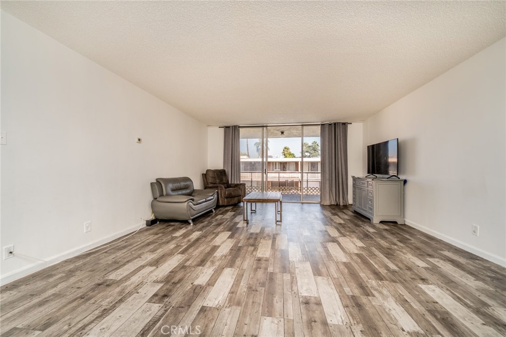 6979 Palm Court, Unit 319F Riverside, CA 92506 - Photo 9 of 44 a living room with furniture and a flat screen tv
