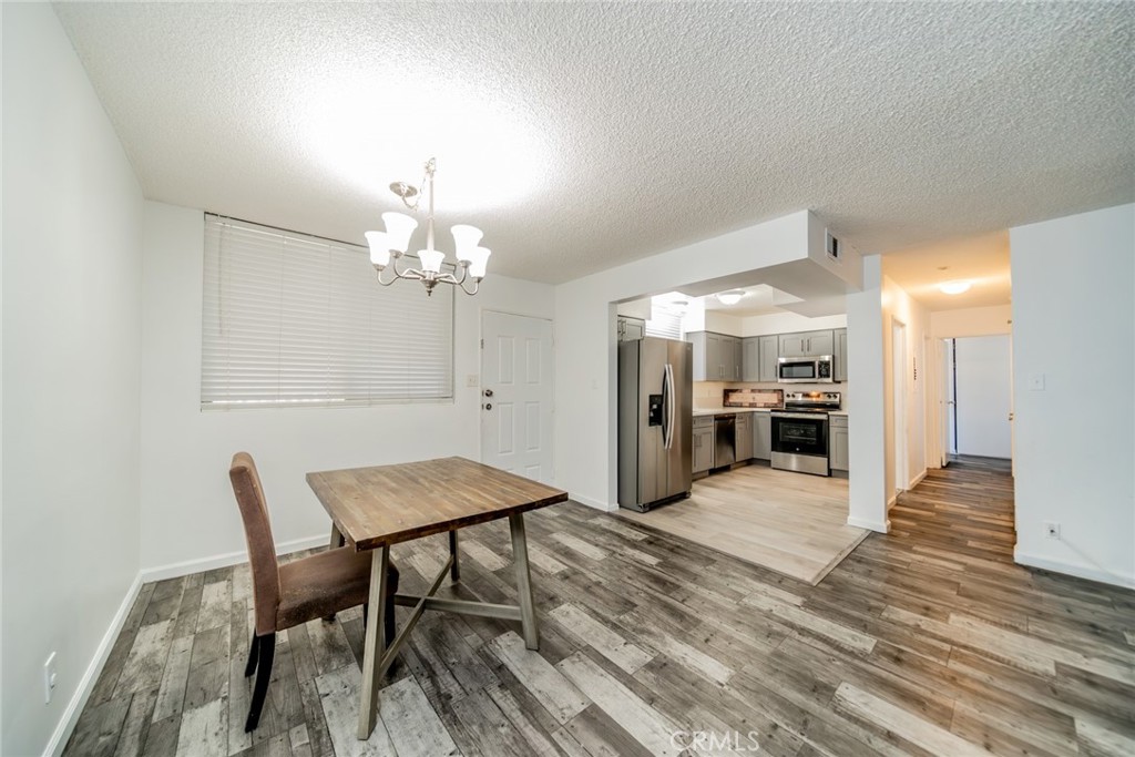 6979 Palm Court, Unit 319F Riverside, CA 92506 - Photo 10 of 44 a view of a dining room with furniture and wooden floor