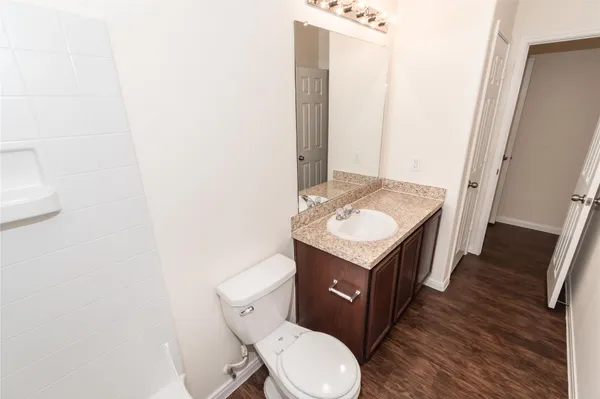 a bathroom with a toilet a sink and a mirror