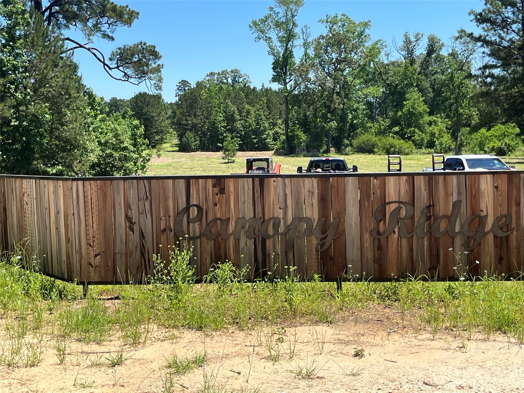 a view of small yard with wooden fence
