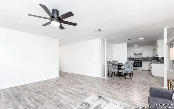 a view of a livingroom with furniture and workspace