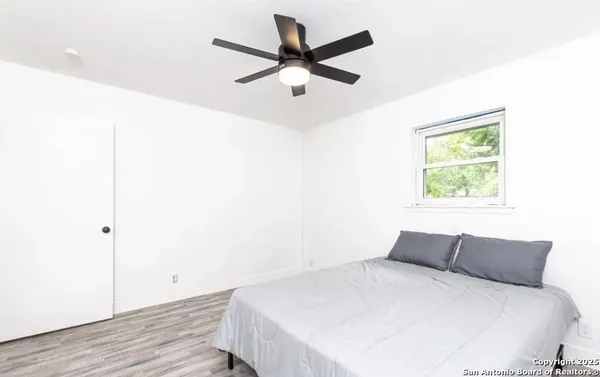 a bedroom with a bed and a window