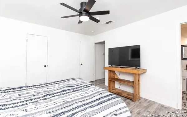 a bedroom with a bed and a flat screen tv