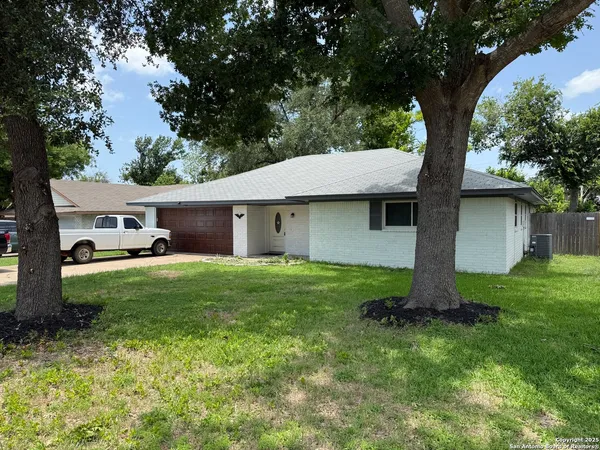 a front view of house with yard and green space