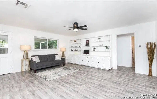 a living room with a bed furniture and a large window