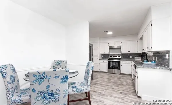 a kitchen with stainless steel appliances kitchen island granite countertop a sink and cabinets