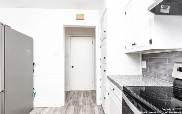 a kitchen with a sink and a refrigerator