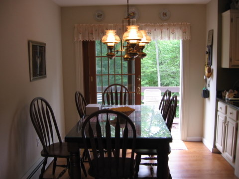 894 Colebrook River Road Tolland, MA 01034 - Photo 14 of 22 a view of a dining room with furniture window and wooden floor