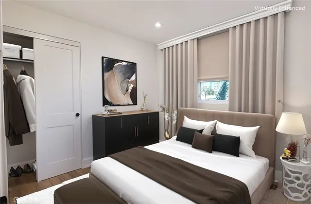 a bedroom with a bed and a flat tv screen