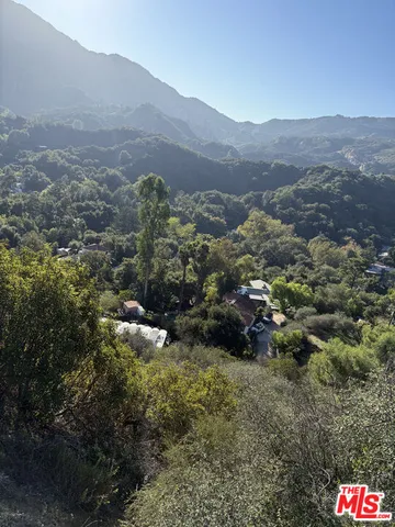 an aerial view of residential house and green space