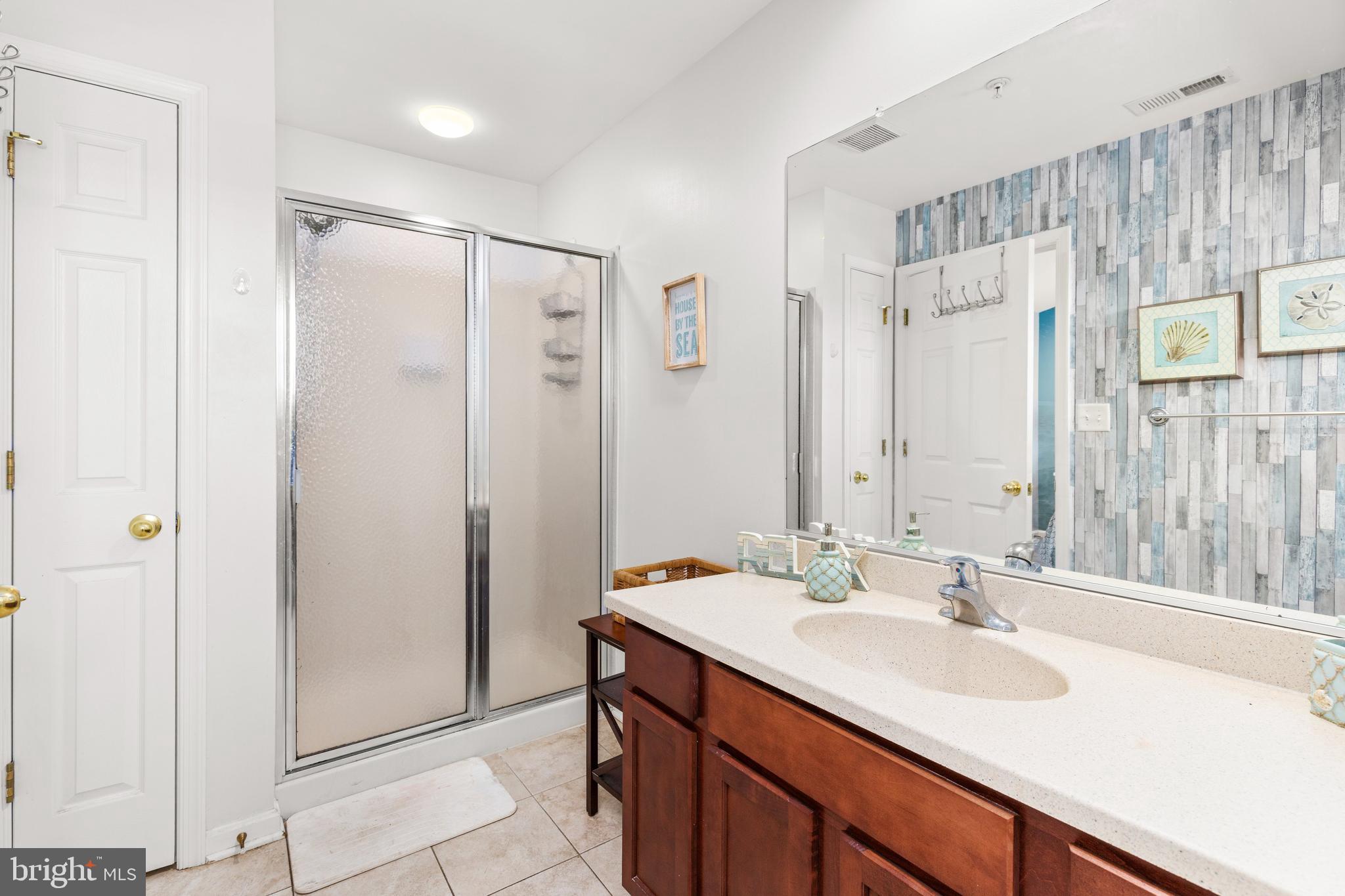 617 Salt Spray Road, Unit B Ocean City, MD 21842 - Photo 55 of 72 a bathroom with a sink double vanity and a mirror
