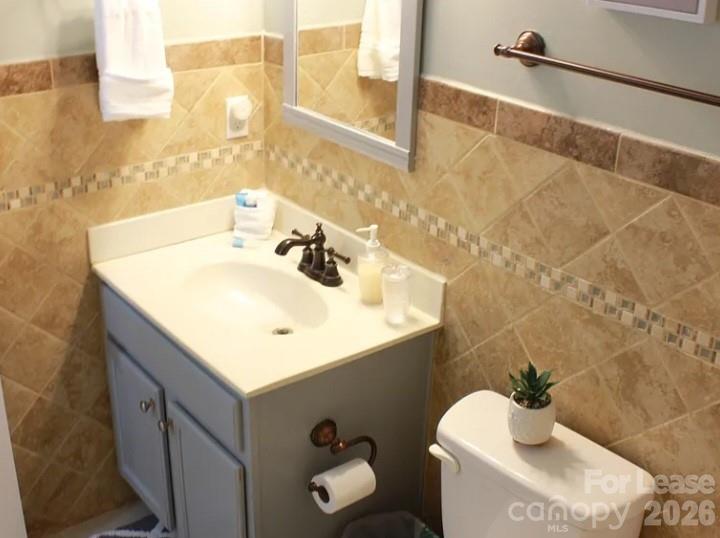 2027 Pimpernel Road Charlotte, NC 28213 - Photo 12 of 12 a bathroom with a sink mirror and toilet