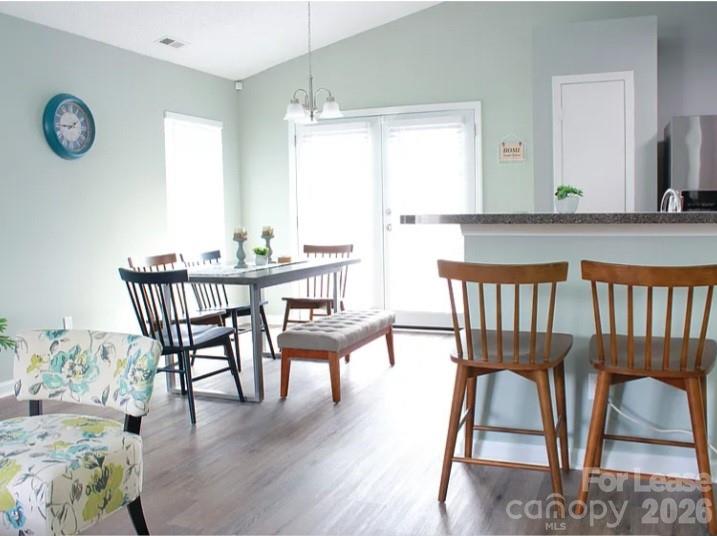 2027 Pimpernel Road Charlotte, NC 28213 - Photo 4 of 12 a view of a dining room with furniture window and wooden floor