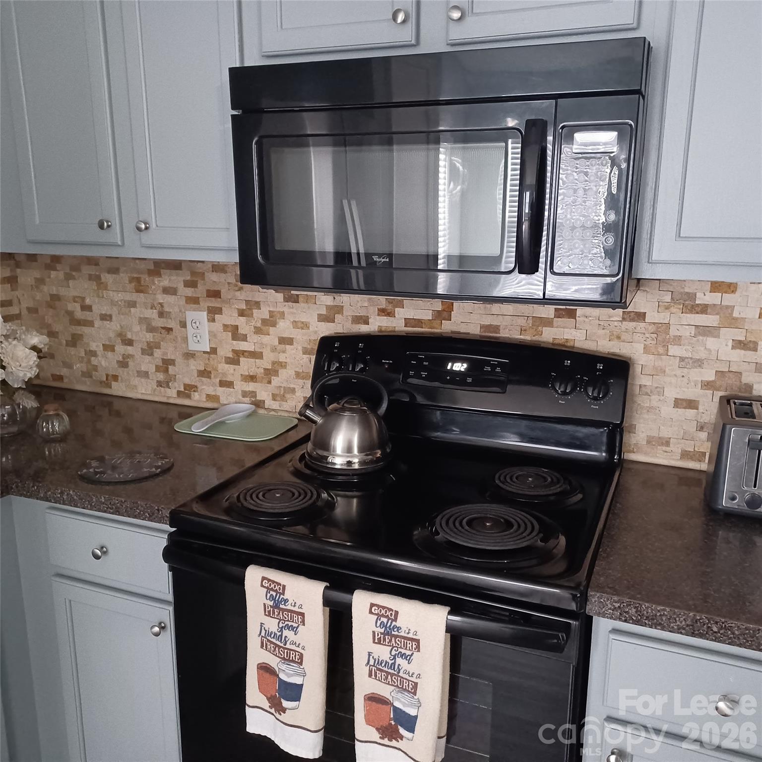 2027 Pimpernel Road Charlotte, NC 28213 - Photo 6 of 12 a kitchen with granite countertop a stove and a microwave