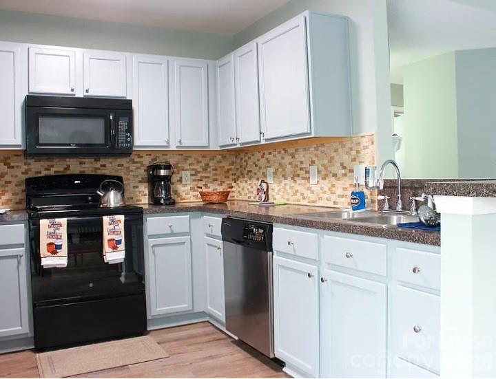 2027 Pimpernel Road Charlotte, NC 28213 - Photo 7 of 12 a kitchen with granite countertop white cabinets and black appliances