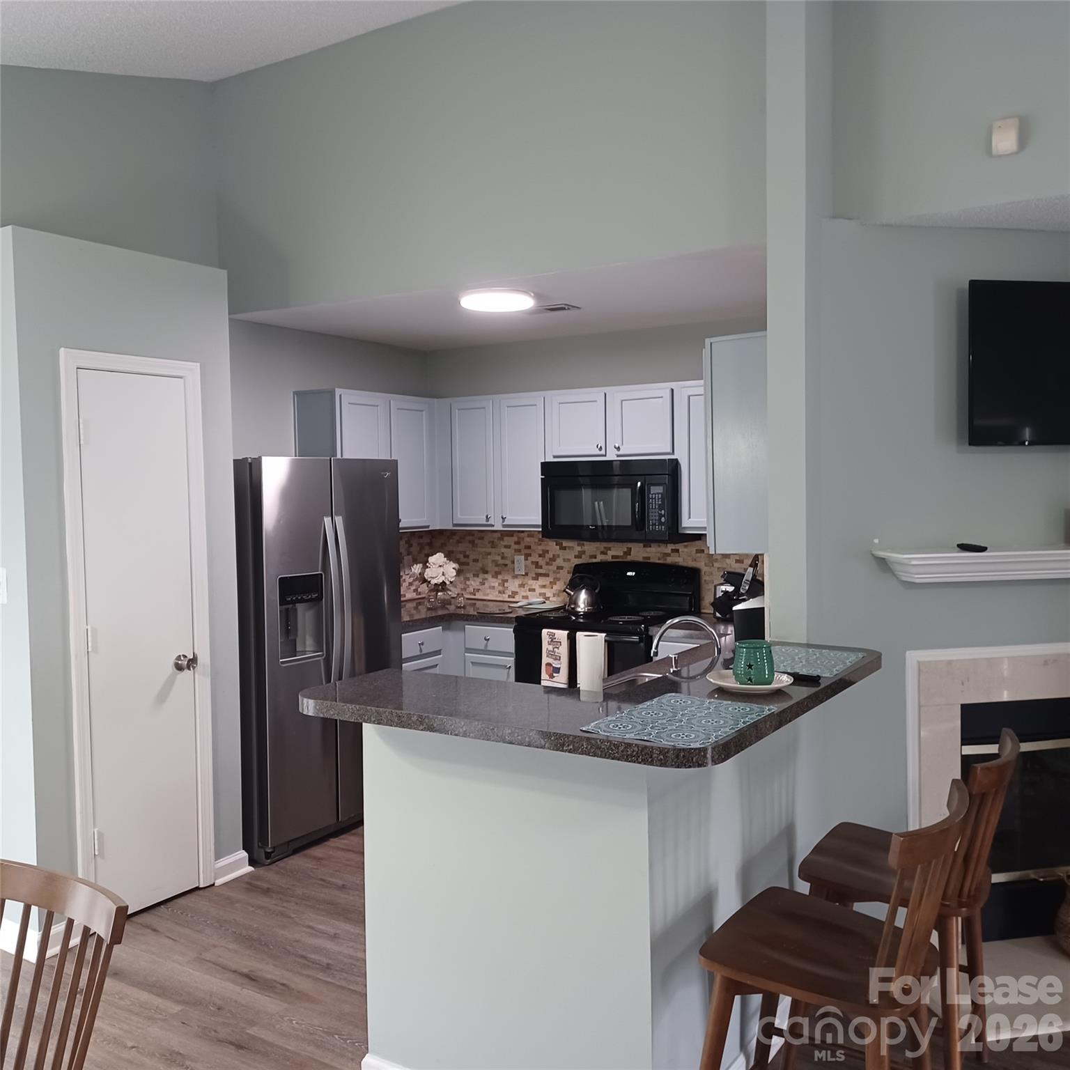 2027 Pimpernel Road Charlotte, NC 28213 - Photo 8 of 12 a kitchen with stainless steel appliances a refrigerator stove microwave and sink