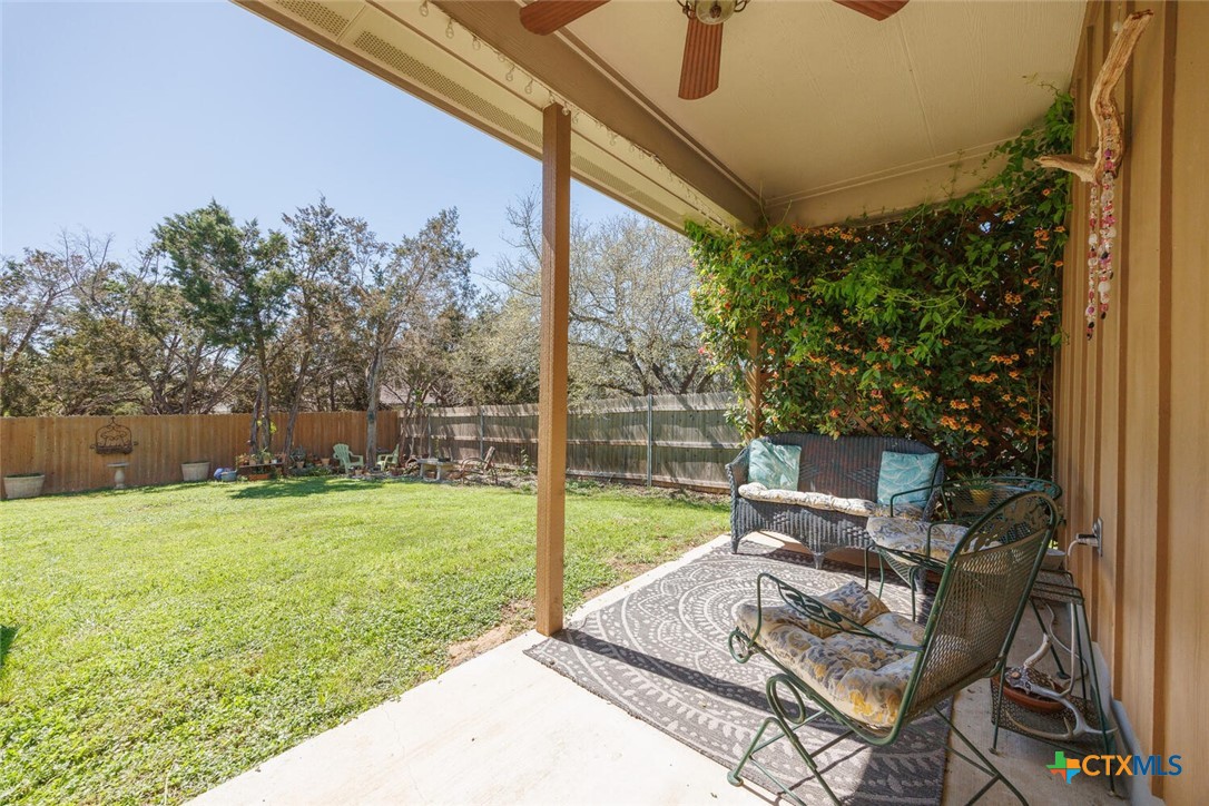1306 Live Oak Drive Spring Branch, TX 78070 - Photo 15 of 18 a view of a patio with a table chairs and a yard