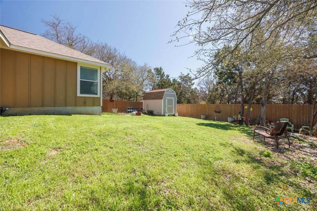 1306 Live Oak Drive Spring Branch, TX 78070 - Photo 17 of 18 a backyard of a house with yard and tree