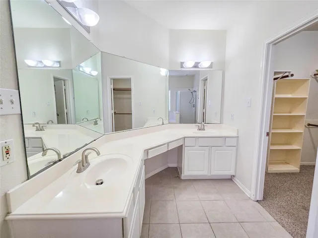 a bathroom with a tub sink and mirror