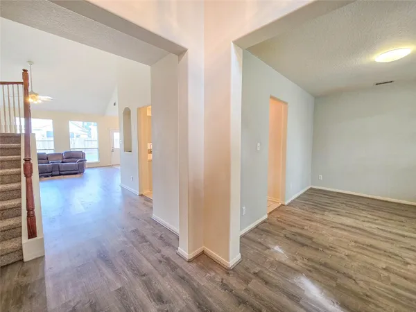 a view of a hallway with wooden floor