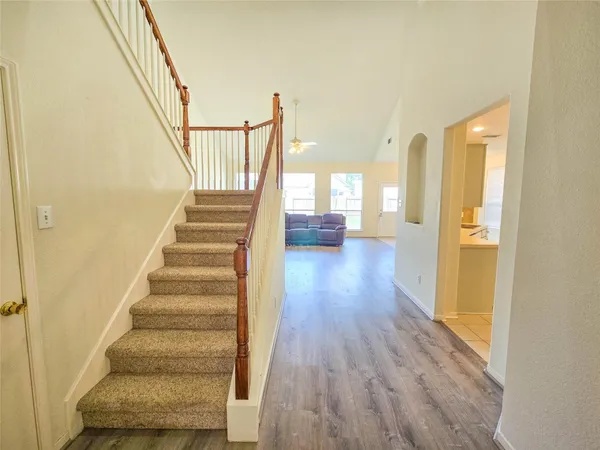 a view of entryway and hall with wooden floor