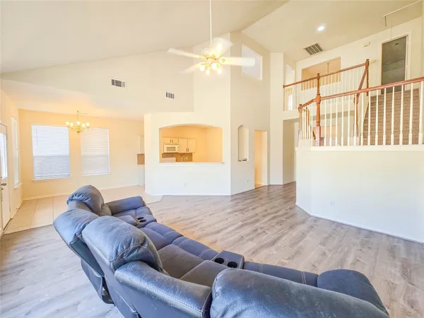 a living room with furniture and a chandelier