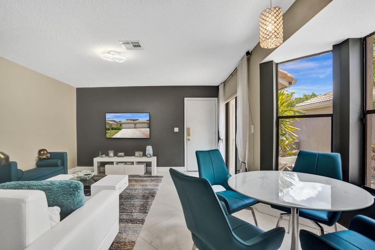 5465 Monterey Circle, Unit D Delray Beach, FL 33484 - Photo 33 of 67 a living room with furniture and a large window