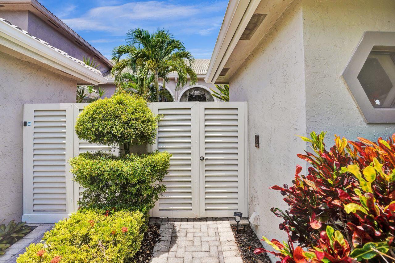 5465 Monterey Circle, Unit D Delray Beach, FL 33484 - Photo 6 of 67 a view of a flower garden with a chair