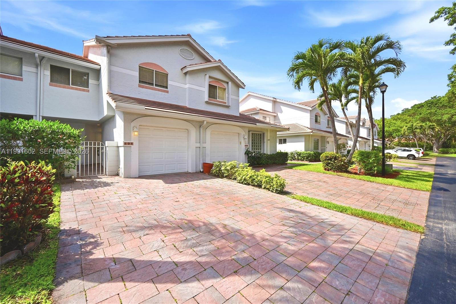 6215 Old Court Road, Unit 505 Boca Raton, FL 33433 - Photo 3 of 36 a front view of a house with a yard and garage