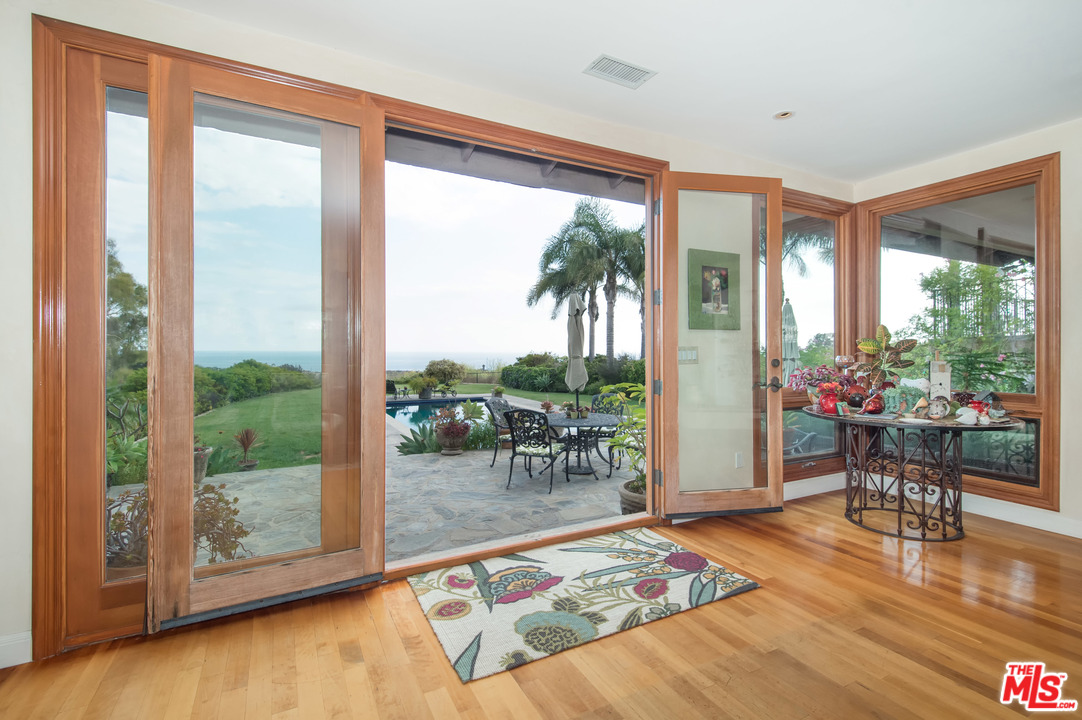 29660 Harvester Road Malibu, CA 90265 - Photo 12 of 32 a living room with hardwood floor and a table