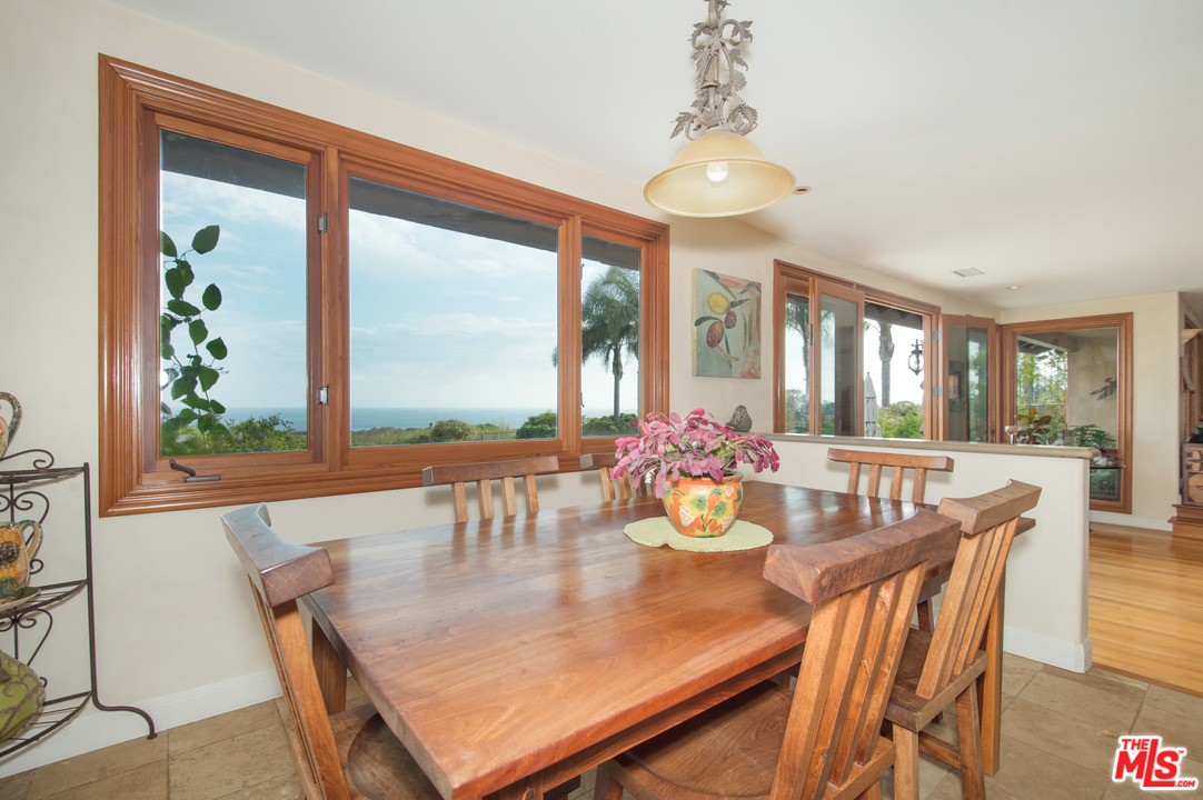 29660 Harvester Road Malibu, CA 90265 - Photo 13 of 32 a view of a dining room with furniture wooden floor and chandelier