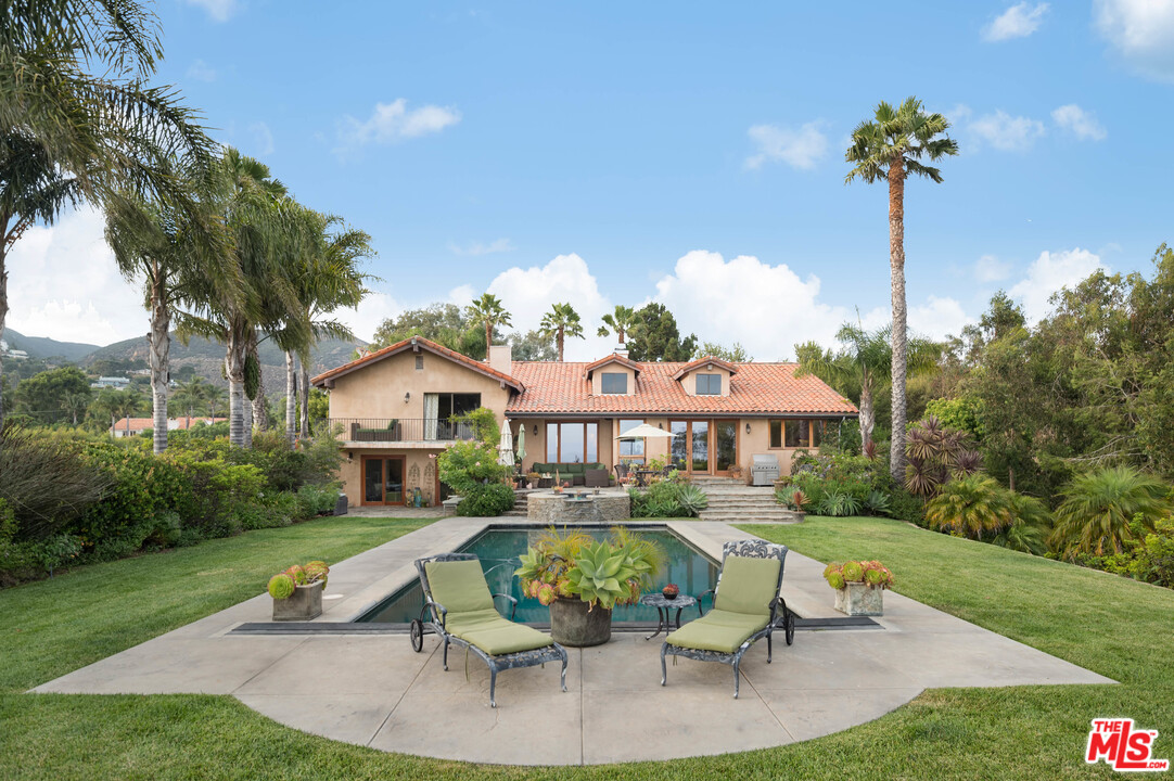 29660 Harvester Road Malibu, CA 90265 - Photo 16 of 32 a view of a house with a yard patio and slide