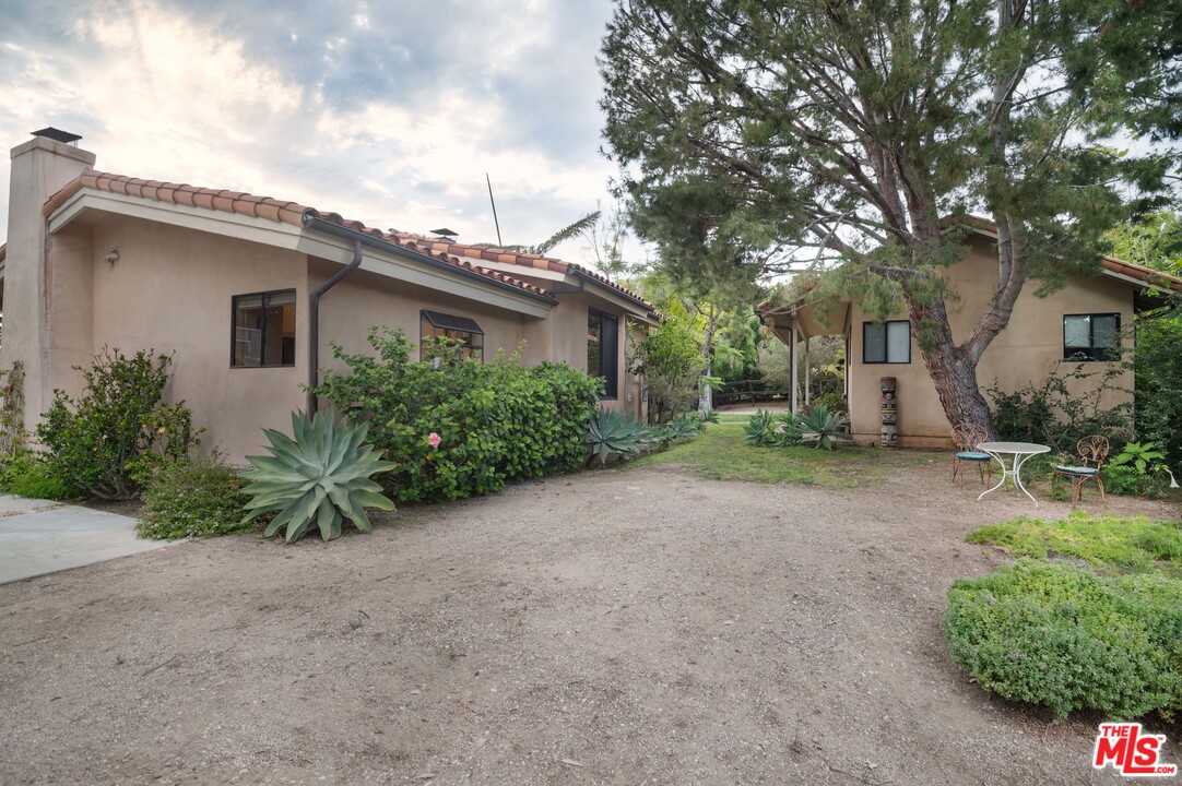 29660 Harvester Road Malibu, CA 90265 - Photo 22 of 32 a view of a house with a yard and plants