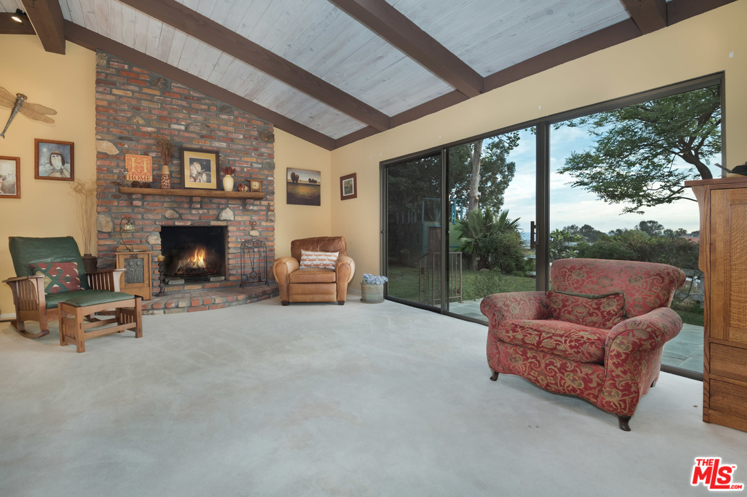 29660 Harvester Road Malibu, CA 90265 - Photo 24 of 32 a living room with furniture and a fireplace