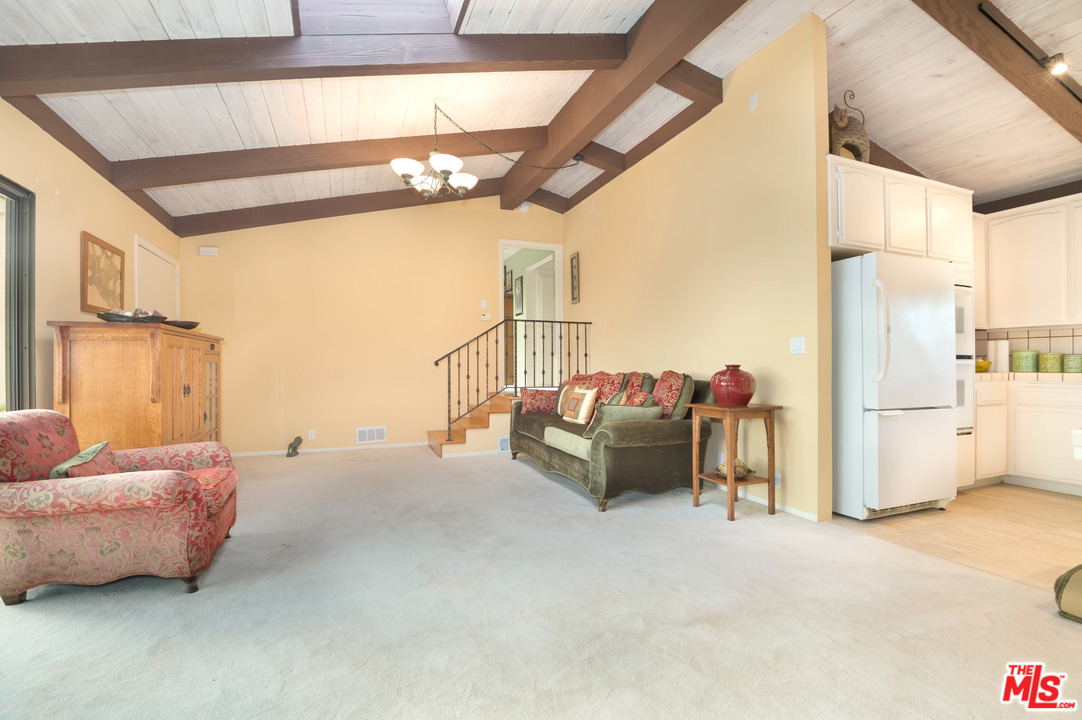 29660 Harvester Road Malibu, CA 90265 - Photo 25 of 32 a living room with furniture and a chandelier