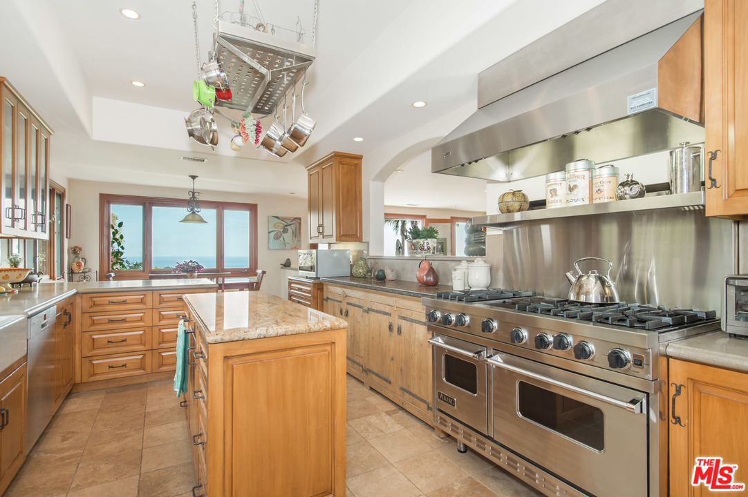 29660 Harvester Road Malibu, CA 90265 - Photo 4 of 32 a kitchen with a stove a sink and a refrigerator