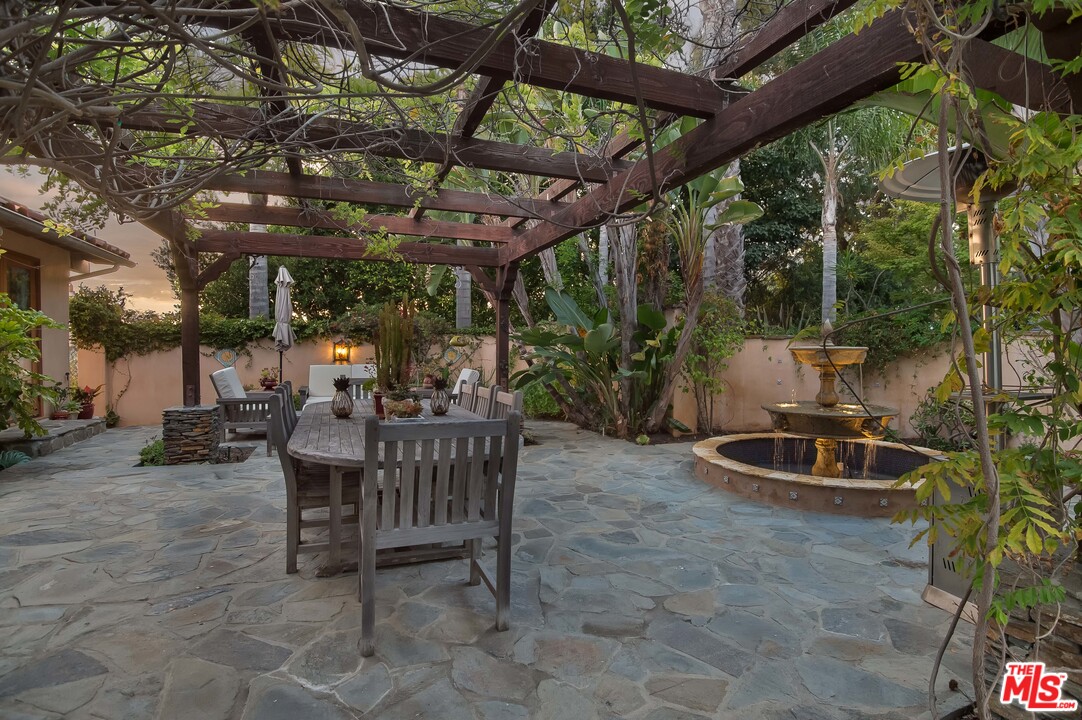 29660 Harvester Road Malibu, CA 90265 - Photo 5 of 32 a backyard of a house with table and chairs
