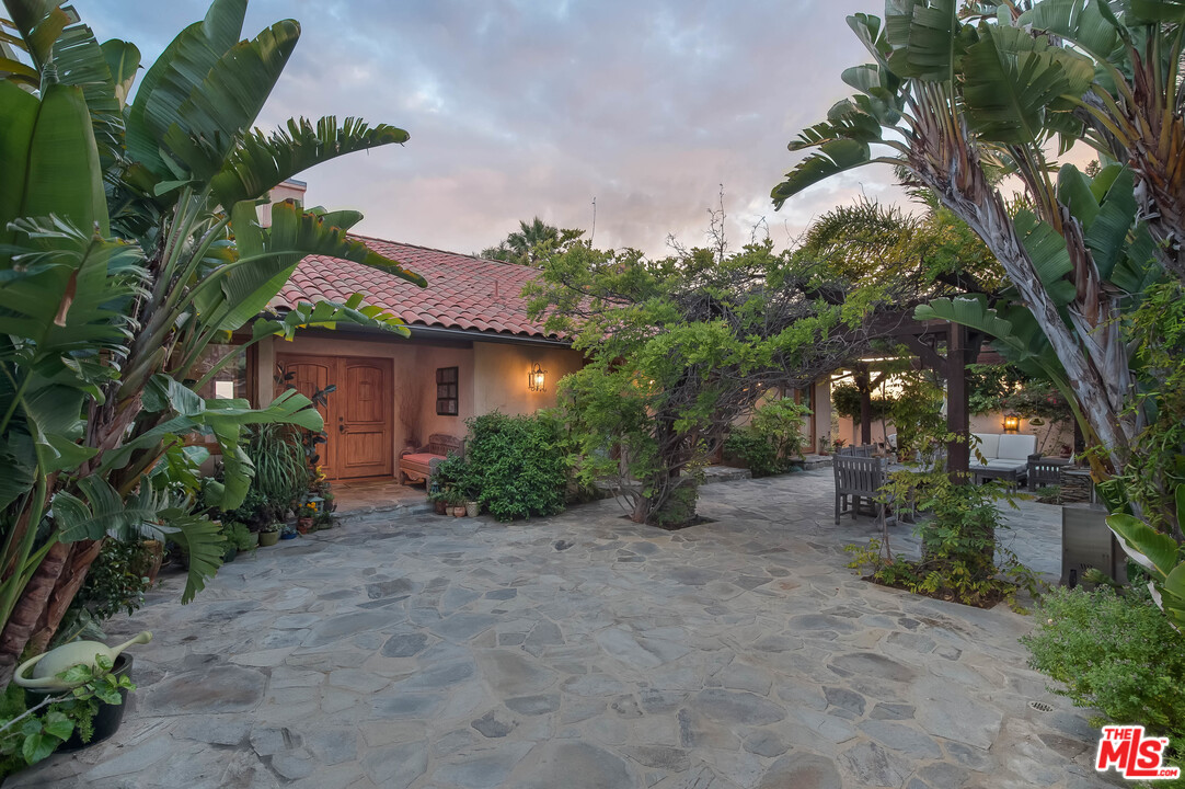 29660 Harvester Road Malibu, CA 90265 - Photo 8 of 32 a view of a house with a flower garden
