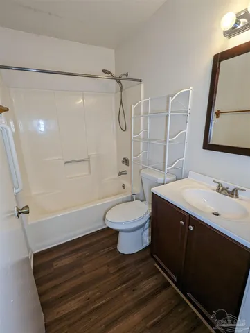 a bathroom with a sink a toilet a mirror and shower