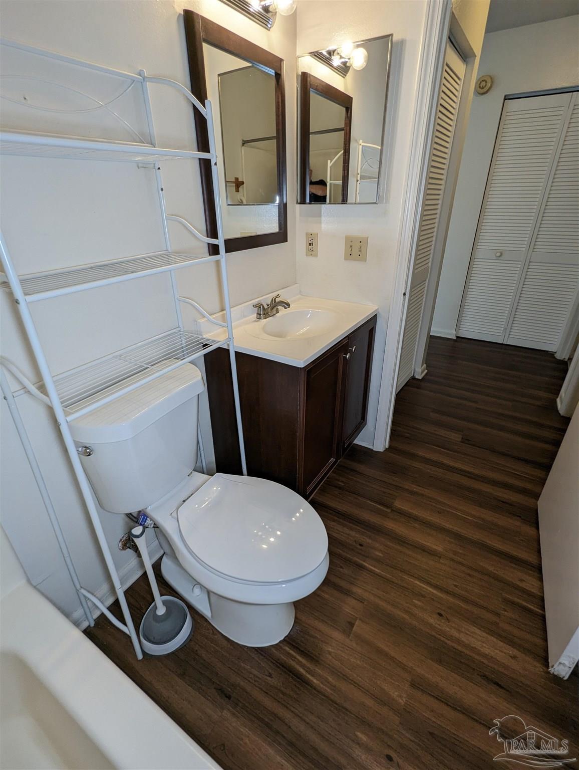 6288 Hamilton Bridge Road, Unit 301 Milton, FL 32570 - Photo 22 of 24 a bathroom with a toilet sink and mirror