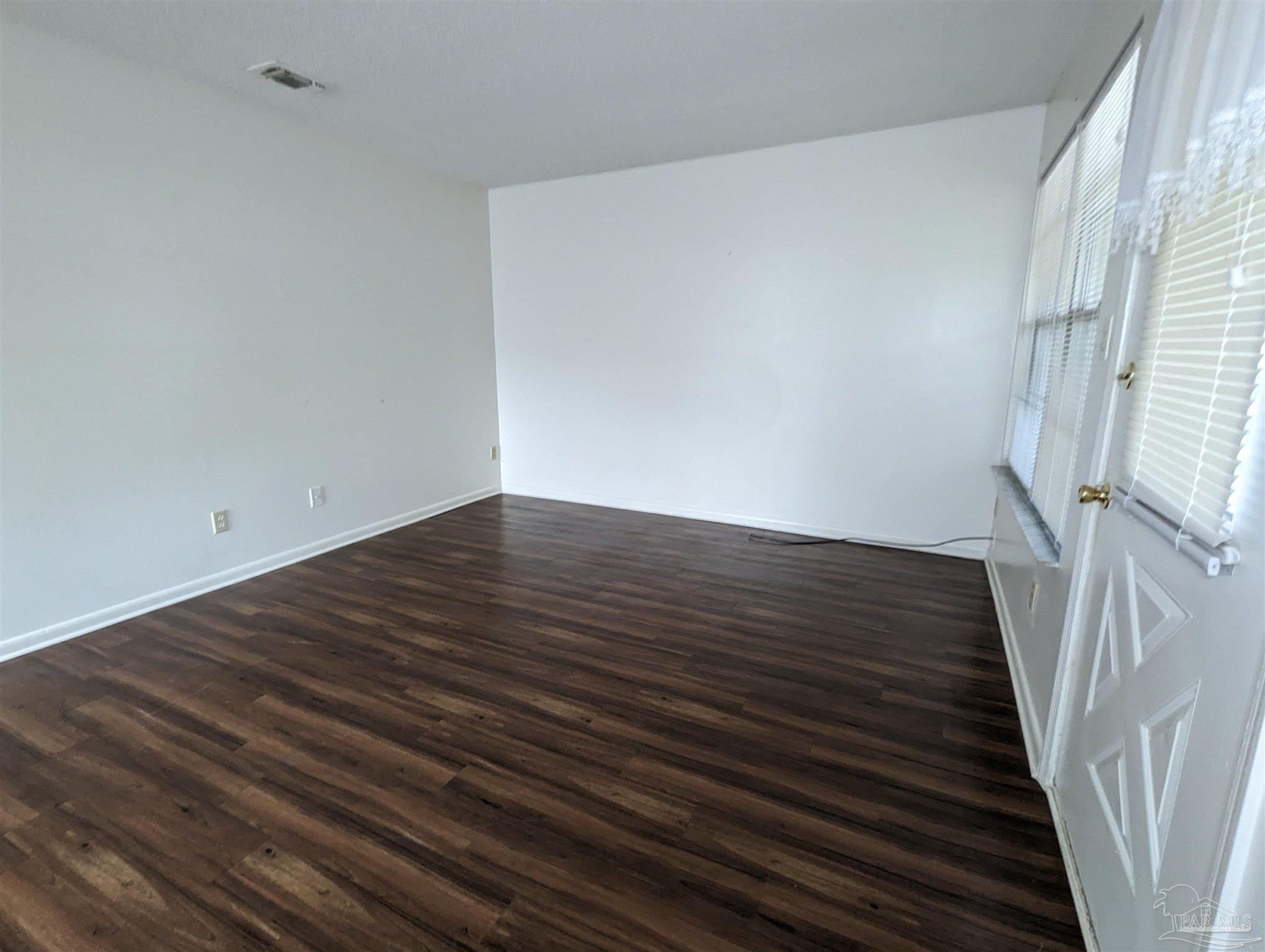 6288 Hamilton Bridge Road, Unit 301 Milton, FL 32570 - Photo 5 of 24 a view of an empty room with wooden floor and stairs