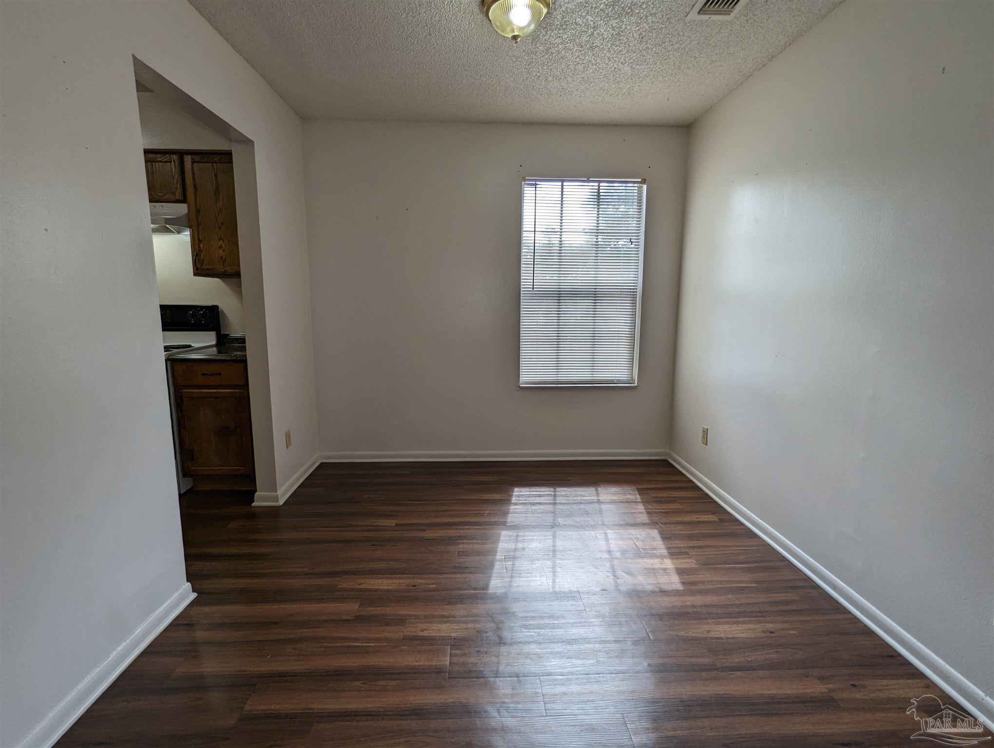 6288 Hamilton Bridge Road, Unit 301 Milton, FL 32570 - Photo 6 of 24 an empty room with wooden floor closet and windows