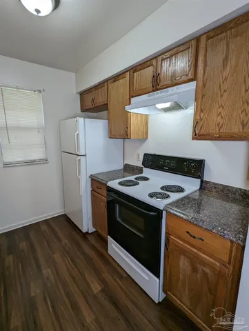 a kitchen with a stove and a refrigerator