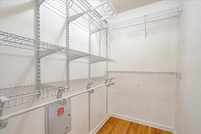 a bedroom with a large bed and a flat tv screen on dresser