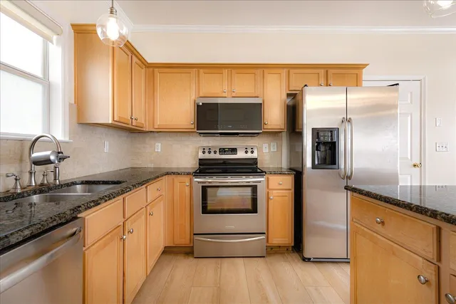a kitchen with a sink stove and refrigerator