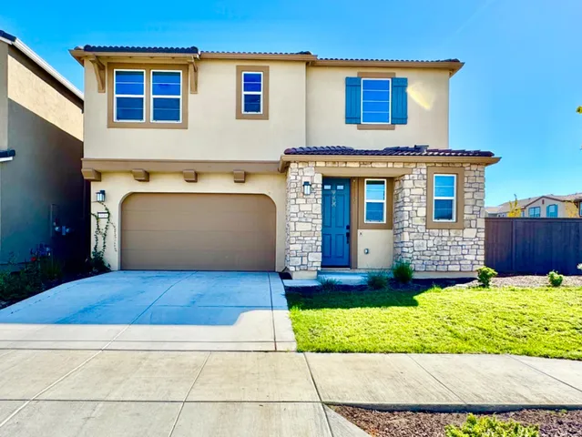 a front view of a house with a yard and garage