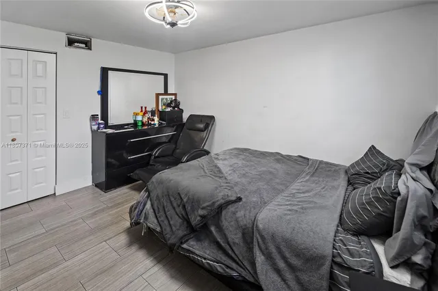 a bedroom with a bed and a mirror