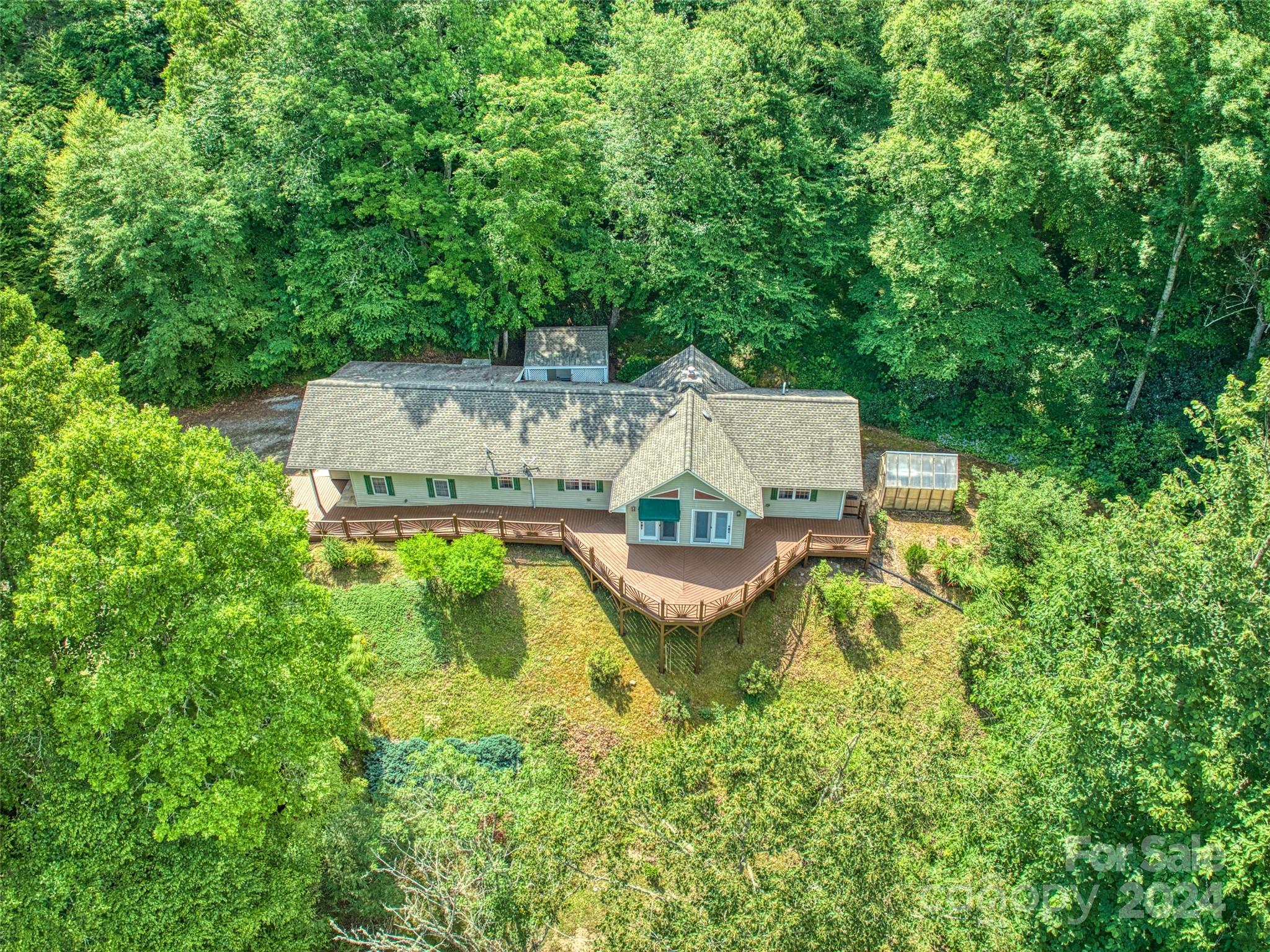 334 Rock House Cove Road Clyde, NC 28721 - Photo 8 of 46 an aerial view of a house with swimming pool a yard and a fountain
