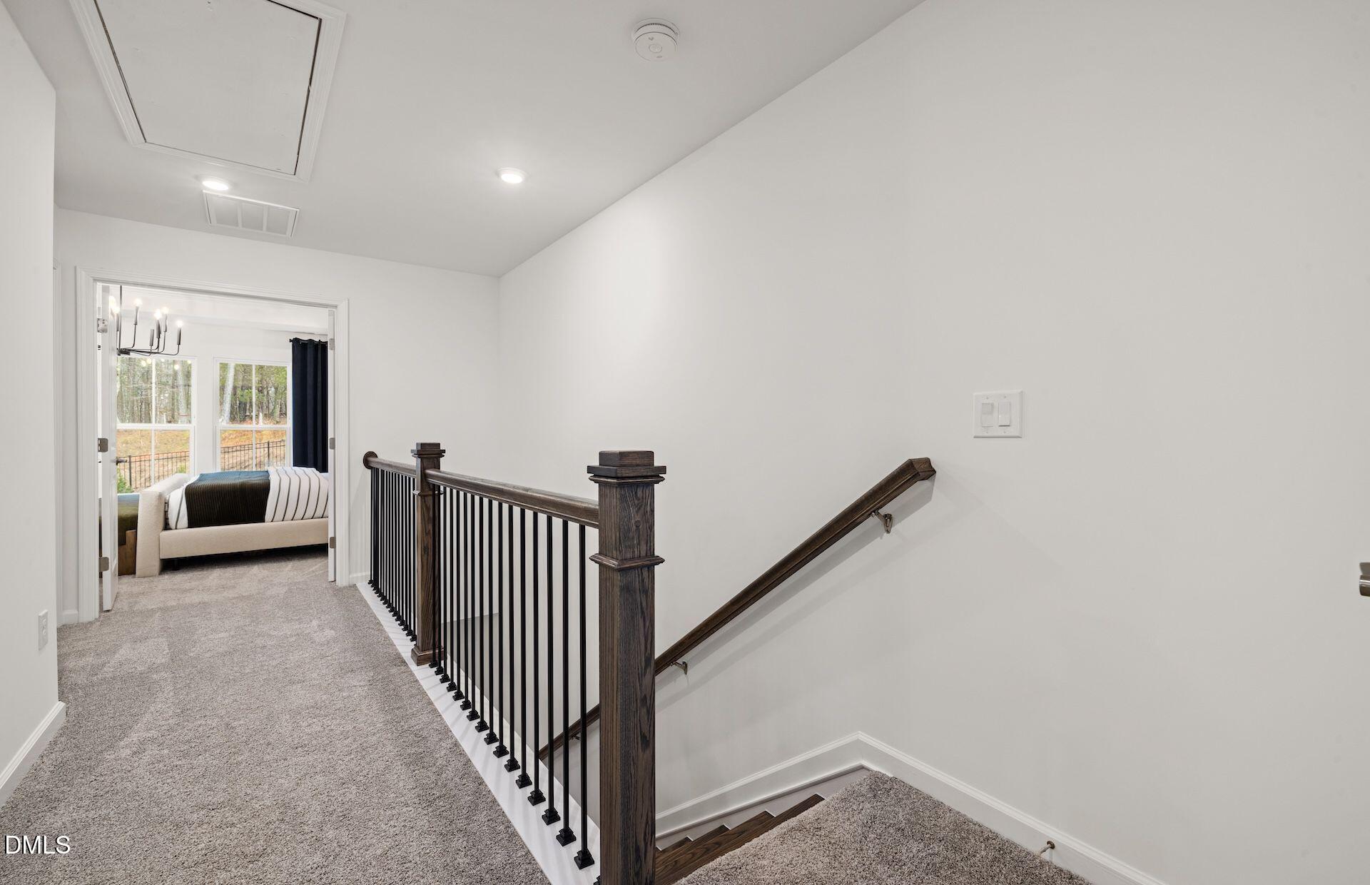 101 Verlands Way Garner, NC 27529 - Photo 16 of 19 a view of a hallway with a white bed and roof
